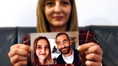 Aya Al Umari holds a photo of herself and her brother Hussein, who was killed in the Christchurch mosque attacks in March 2019. AP