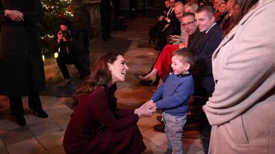 Catherine, Princess of Wales, plays with a child before the service. AFP