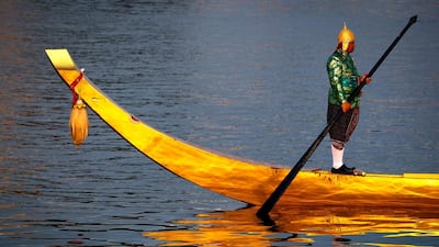 A Thai Royal Navy oarsman steers a Royal Barge during the full dress rehearsal of the Royal Barge Procession to honour the occasion of the Coronation of Thai King Rama X. EPA