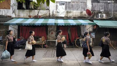 Students holding their carved watermelons, are walking in the line back to the dorm which takes about 0.7 km from the school. Sasamon Rattanalangkarn for The National