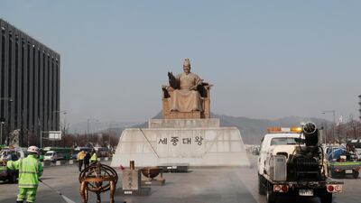 A worker and vehicle spray disinfectant and water as a precaution against the new coronavirus in front of the statue of King Sejong in the Joseon Dynasty, at the Gwanghwamun Plaza in Seoul, Thursday, Feb. 20. The mayor of the South Korean city of Daegu urged its 2.5 million people on Thursday to refrain from going outside as cases of the new virus spike. (AP Photo/Ahn Young-joon)