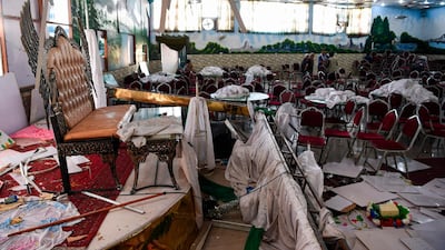 Afghan men investigate in a wedding hall after the deadly bomb blast. AFP
