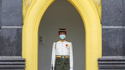 A Malaysian Royal Guard wears a protective mask while he stands guard outside National Palace, following the outbreak of a new coronavirus in China, in Kuala Lumpur, Malaysia. REUTERS