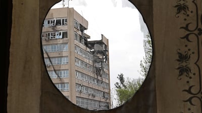 War damage to a building in Tehran, Iran, is framed by a curtain placed on the Golestan Palace, a Unesco World Heritage site. AFP