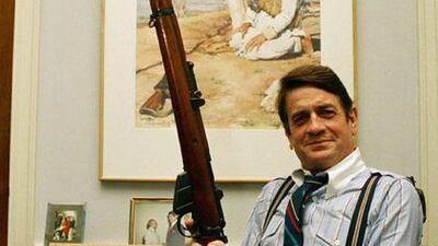 Rep Charlie Wilson holds a British Enfield rifle in his Capitol Hill office in Washington in 1988.