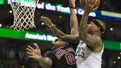 Boston Celtics guard Isaiah Thomas scores past defending Chicago Bulls guard Isaiah Canaan at the TD Garden in Boston, Massachusetts, on April 16, 2017. CJ Gunther / EPA