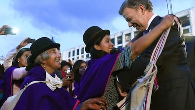 Colombian president Juan Manuel Santos receiving handicrafted presents from Misak natives. AFP Photo