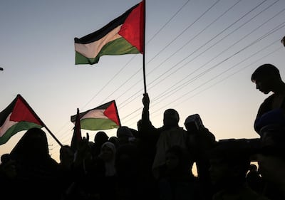 Palestinian protesters wave their national flags in a demonstration this week near the Erez crossing with Israel in the northern Gaza Strip, protesting the United States decision to stop funding and backing the United Nations agency for Palestinian refugees(UNRWA). Mahmud Hams / AFP)