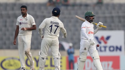 India's Ravichandran Ashwin, left, and Rishabh Pant, center, celebrate the dismissal of Bangladesh's Mominul Haque, right, during the first day of the second cricket test match between Bangladesh and India, in Dhaka, Bangladesh, Thursday, Dec. 22, 2022. (AP Photo / Surjeet Yadav)