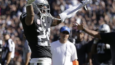 Oakland Raiders defensive back Charles Woodson celebrates an interception against the Denver Broncos last Sunday in the NFL. Marcio Jose Sanchez / AP / October 11, 2015