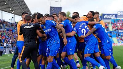 Getafe's Mason Greenwood, centre left joins in the celebrations after Nemanja Maksimovic's winner. AP