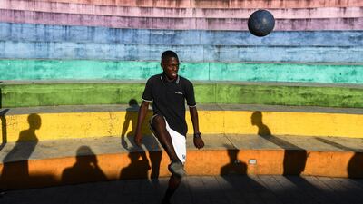 A man plays football in the Haitian capital Port-au-Prince. AFP