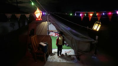 Displaced Palestinians in Rafah decorate their tent in preparation for the start of Ramadan. Getty Images