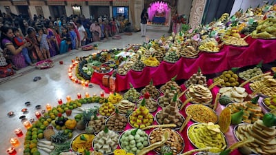 Devotees pray next to sweets and fruits that are kept as offerings by the devotees as part of a ritual to mark Annakut festival during Diwali in Ahmedabad, India. Reuters