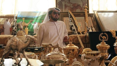 Racing camel owner Mohammed Zayed Al Mansoori at his farm at Al Dhafra in the Western Region of Abu Dhabi with just some of the trophies won by his camels in racing competitions round GCC countries. Ravindranath K / The National