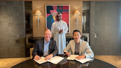 Sheikh Tahnoun bin Zayed, Deputy Ruler of Abu Dhabi and chairman of G42, witnesses the signing ceremony between Peng Xiao, group chief executive of G42, right, and Brad Smith, vice chairman and president of Microsoft. Photo: G42