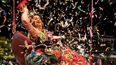 'Sushi', portrayed by female impersonator Gary Marion, hangs in a giant replica of a woman's red high-heeled shoe over Duval Street in Key West, Florida. The Red Shoe Drop is a 24-year-old New Year's Eve tradition. AP