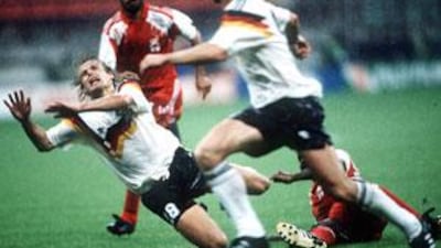 UAE captain Abdulrahman Mohammed looks on as West Germany's striker Jurgen Klinsmann is fouled.