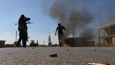 Fighters from the Free Syrian Army battle ISIL on the outskirts of the northern Syrian town of Dabiq.Nazeer al Khatib / AFP