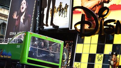 6th: New York. Tourists ride on a city tour bus passing billboards advertising various products in New York. Jewel Samad / AFP