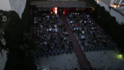 Moviegoers watch the 1965 French science fiction film Alphaville, at the Zefyros vintage-movie cinema in Ano Petralona.