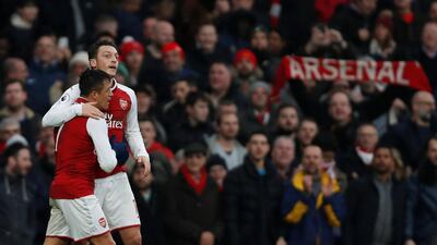 Alexis Sanchez, left, is congratulated by Mesut Ozil after scoring Arsenal's second goal in their 2-0 win over Tottenham Hotspur. Paul Childs / Reuters
