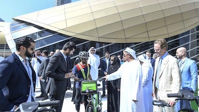 Officials from Careem and the city's transport authority unlock the first bikes on Saturday morning. Courtesy: RTA