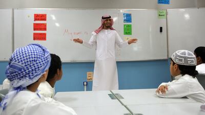 Ahmed Al Maamari, an Emirati teacher, with Grade 3 pupils at Al Aasimah School in Shamkha, Abu Dhabi. Ravindranath K / The National