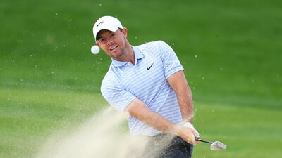 Rory McIlroy plays out of a bunker on the 2nd hole. Getty