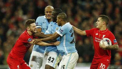 Manchester City's Yaya Toure clashes with Liverpool's Adam Lallana. Action Images via Reuters / Paul Childs