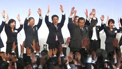 Japan's prime minister Shinzo Abe (centre) shouts "Banzai!" (cheers) as he throws his hands in the air with members of the ruling Liberal Democratic Party (LDP) during the annual party convention in Tokyo in January. Yuya Shino / Reuters