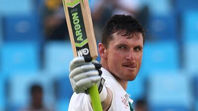 South African captain Graeme Smith (L) celebrates a double century during the second day of the second Test Match between Pakistan and South Africa at the Dubai International Cricket Stadium October 24, 2013. AFP PHOTO/ MARWAN NAAMANI