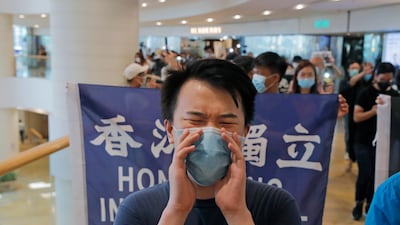 Protesters hold flags and shout slogans in a shopping mall during a protest in Hong Kong. Protesters in Hong Kong managed to make the government withdraw extradition legislation last year, but now they're getting a more dreaded national security law and the message from Beijing is that protest is futile. AP Photo