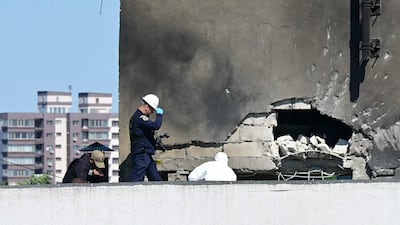 Romanian emergency personnel assess the damage to the residential building struck by a Russian drone. AFP