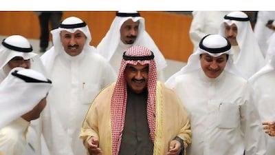 The Kuwaiti Prime Minister Sheikh Nasser Al Mohammad Al Sabah, centre, survived the non-cooperation vote 25-18. Raed Qutena / EPA