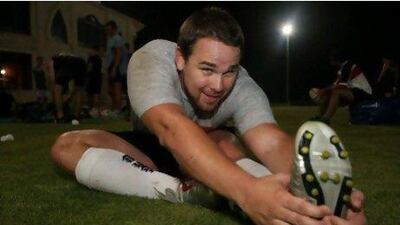 Pete Sampson stretches after practice.