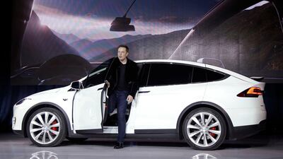 Elon Musk, CEO of Tesla,exots a Model X. The company will cut prices for the vehicle by 6 per cent. Marcio Jose Sanchez/AP