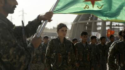 Syrian Kurds march during the funeral of fighters killed in an assault against ISIL in the town of Manbij, in the Syrian Kurdish town of Kobani on June 4, 2016. Delil Souleiman / AFP
