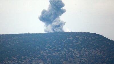 A plume of smoke from an air bombardment rises from an impact inside Syria as seen from the Hatay province, Turkey, near the border Wednesday, Jan. 24, 2018. AP