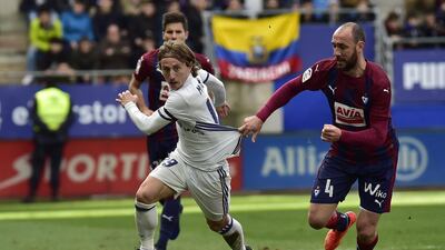 Real Madrid’s Luka Modric, left duels for the ball with Eibar’s Ivan Ramis. Alvaro Barrientos / AP Photo