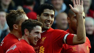 Luis Suarez, second from the right, celebrates after Liverpool's English midfielder Raheem Sterling scored the team's second goal in a 3-1 win over Cardiff City at Anfield Stadium in Liverpool. Paul Ellis / AFP