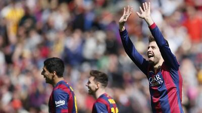 Barcelona's Gerard Pique celebrates next to Luis Suarez and Lionel Messi after scoring against Rayo Vallecano in his side's 6-1 La Liga win on Sunday. Albert Gea / Reuters