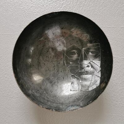 'Untitled' (2018) by Jassim Al Awadhi is one of the pieces on show. It's a concave rounded piece of iron, 40 cm wide in diameter. Courtesy Tashkeel