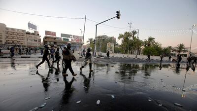 Riot police disperse people during the protest in Baghdad. Reuters