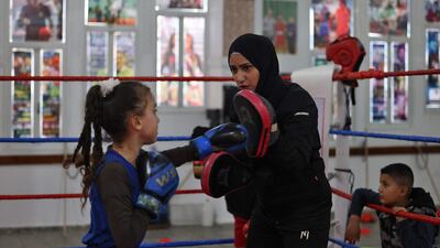 There are posters of boxing heroes such as Mike Tyson on the walls