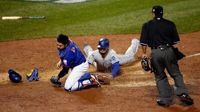 Eric Hosmer #35 of the Kansas City Royals scores a run off of a grounded out hit by Salvador Perez #13 to tie the game in the ninth inning against Jeurys Familia #27 of the New York Mets during Game Five of the 2015 World Series at Citi Field on November 1, 2015 in the Flushing neighborhood of the Queens borough of New York City. Sean M. Haffey/Getty Images/AFP