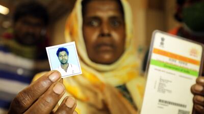 Jenima Mondal shows a photo of her missing son Majur Ali Mondal, as she visits a morgue. She later found out he had been killed. EPA
