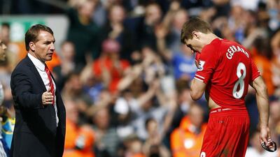 Liverpool’s Steven Gerrard, right, is greeted by manager Brendan Rodgers as he leaves the pitch following their English Premier League soccer match against Chelsea at Anfield in Liverpool, northern England April 27, 2014. REUTERS/Darren Staples