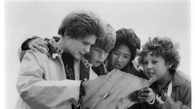 From left to right, Corey Feldman, Sean Astin, Ke Huy Quan and Jeff Cohen read a treasure map in a scene from the film. Getty
