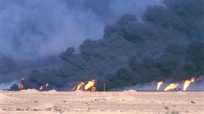Smoke fills the air from oil wells that were set on fire by Iraqi forces during the Gulf War. Getty